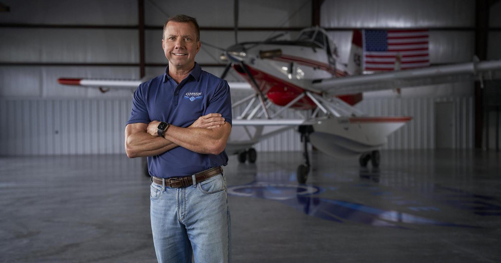 Man in front of airplane in hangar