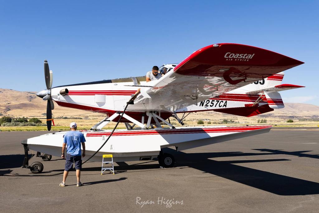 scooper plane on ground with crew members